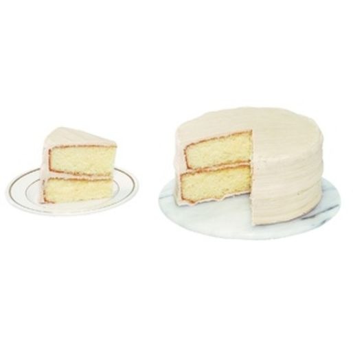 A simple two-layer yellow cake with light frosting, shown with a single slice on a plate.