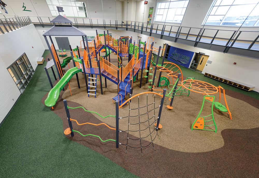Indoor playground area at Rustad Recreation Center with climbing structures, slides and family recreation space.